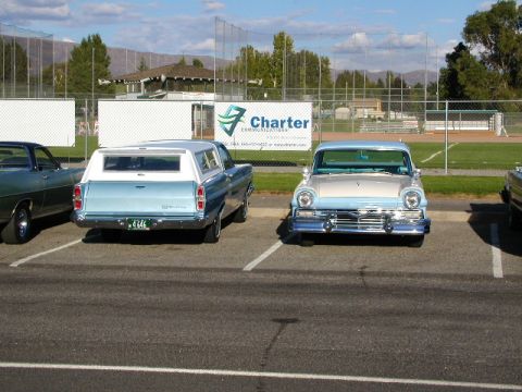 1967 Ford Ranchero - A light blue 1967 Ford Ranchero is parked next to another vehicle, viewed from the rear.