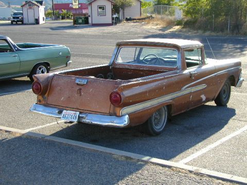 1967 Ford Ranchero - A weathered 1959 Ford Ranchero is parked next to another vehicle in a lot.