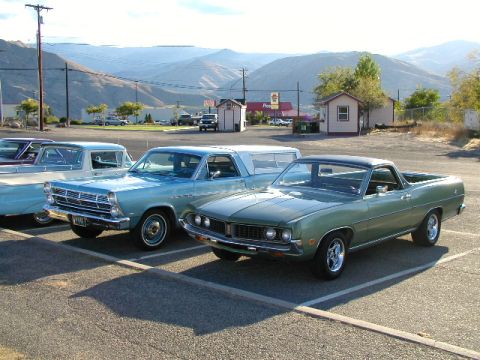 1967 Ford Ranchero - A green 1969 Ford Ranchero is parked in a lot with other vehicles, including a light blue 1965 Ford Ranchero.