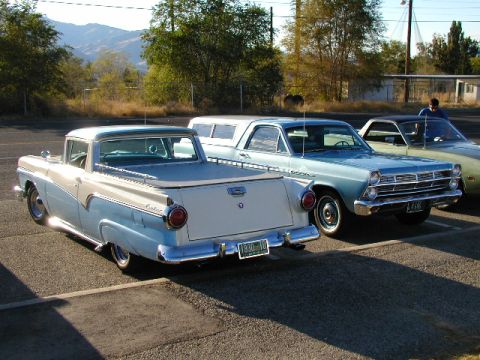 1967 Ford Ranchero - Two Ford Rancheros are parked in a lot, with a third vehicle in the background.