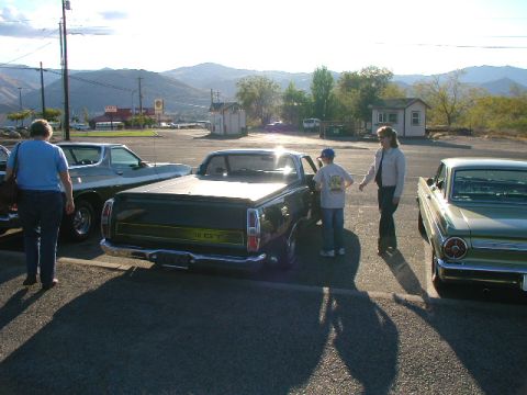1967 Ford Ranchero - A 1967 Ford Ranchero is parked next to other vehicles under a bright sky.