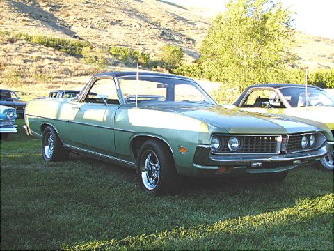 1967 Ford Ranchero - A green 1970 Ford Ranchero is parked on a grassy field next to another vehicle.