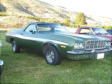 1967 Ford Ranchero - A green Ford Ranchero is parked on a grassy field with a red Ranchero behind it.