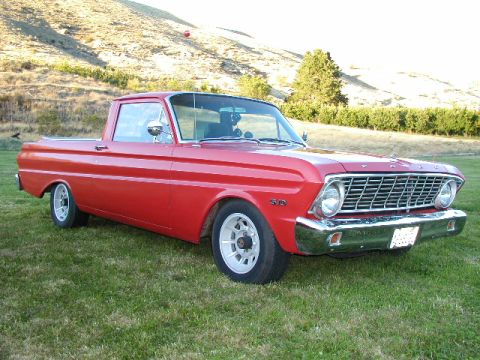 1967 Ford Ranchero - A red 1967 Ford Ranchero pickup truck sits on a grassy lawn.