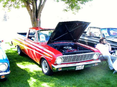 1967 Ford Ranchero - Red 1967 Ford Ranchero on display with its hood up, showing the engine bay.