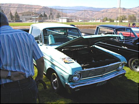 1967 Ford Ranchero - A light blue 1965 Ford Falcon Ranchero is displayed with its hood open, alongside another vehicle.