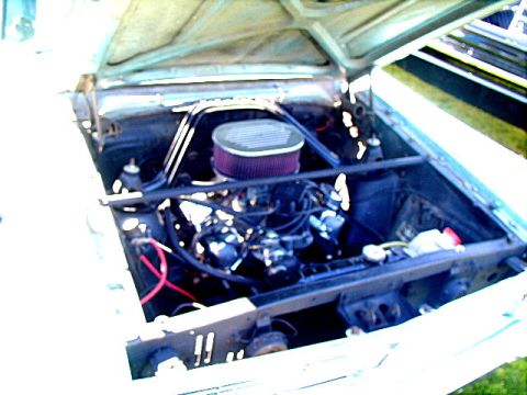 1967 Ford Ranchero - Engine bay view of a 1967 Ford Ranchero, showing its V8 engine with dual carburetors.