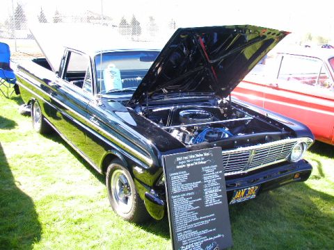1967 Ford Ranchero - A black 1965 Ford Falcon Ranchero is displayed with its hood open, showing the engine bay.