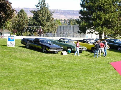 1967 Ford Ranchero - A black 1970 Ford Ranchero is displayed at an outdoor event with other vehicles and people.