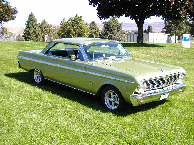 Green 1965 Ford Falcon coupe parked on grass