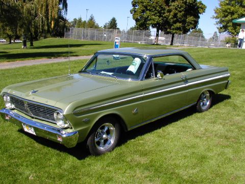 1967 Ford Ranchero - A classic green Ford Falcon sits on a grassy field under a clear blue sky.