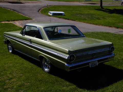 1967 Ford Ranchero - A green 1964 Ford Falcon coupe is shown from the rear quarter angle on a grassy area.