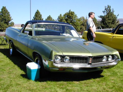 1967 Ford Ranchero - A green 1970 Ford Ranchero is displayed on a sunny day next to a yellow vehicle.
