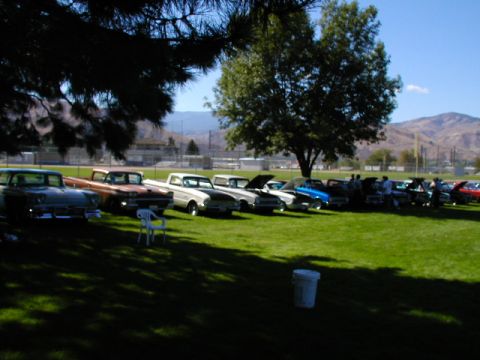1967 Ford Ranchero - A collection of vintage vehicles are displayed on a sunny day in a park-like setting.