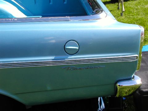 1967 Ford Ranchero - Close-up of a light blue 1967 Ford Ranchero's rear side, showing the fuel cap and model designation.