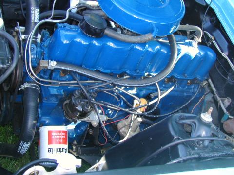 1967 Ford Ranchero - Close-up of a blue painted V8 engine in an engine bay, showing various components and wiring.