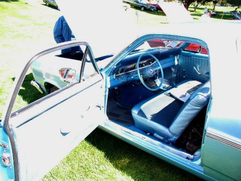 1967 Ford Ranchero - The interior of a light blue 1967 Ford Ranchero is visible with the driver's side door ajar.