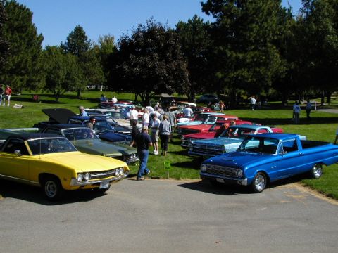 1967 Ford Ranchero - Two Ford Rancheros, a yellow 1967 and a blue earlier model, displayed at a car show event.