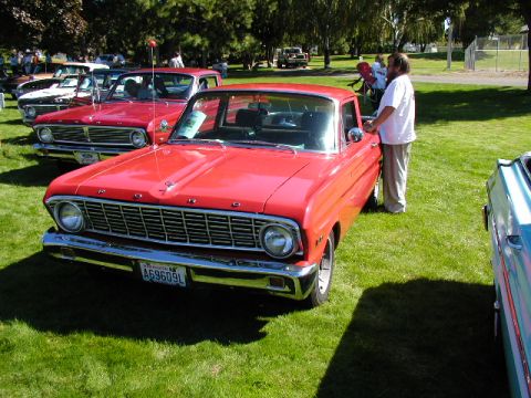 1967 Ford Ranchero - A red 1967 Ford Ranchero is displayed at an outdoor car show event.