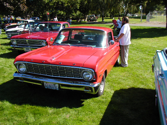 Red Ford Ranchero front 3/4 view on show grass with FORD hood lettering