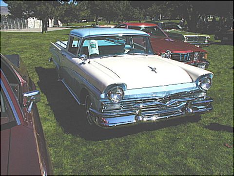 1967 Ford Ranchero - This two-tone 1957 Ford Ranchero is displayed on a grassy field alongside other classic vehicles.