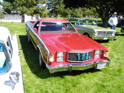 1967 Ford Ranchero - A red 1977 Ford Ranchero is parked on a grassy lawn with other vehicles and people in the background.