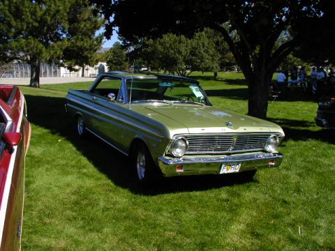 1967 Ford Ranchero - A light green 1965 Ford pickup truck is parked on a grassy lawn with trees in the background.