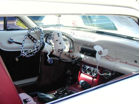 1967 Ford Ranchero - The interior of a 1967 Ford Ranchero features a unique chain-wrapped steering wheel and a classic dashboard fan.