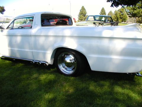 1967 Ford Ranchero - A white 1960 Ford Ranchero pickup truck is parked on grass, with another vehicle visible in the background.