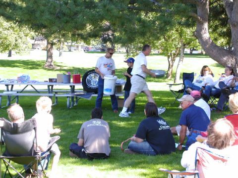 1967 Ford Ranchero - A group of people are gathered outdoors for an event, with a spare tire visible on a picnic table.