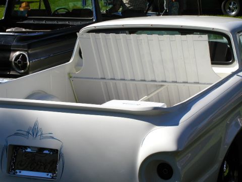 1967 Ford Ranchero - The rear of a white 1967 Ford Ranchero shows custom pinstriping and a license plate frame.