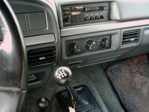 1992 Ford Bronco - Interior view of a 1992 Ford Bronco, highlighting the manual transmission shifter and dashboard details.