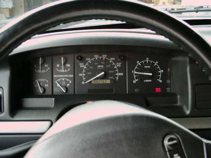 Vehicle gauge cluster with speedometer, tachometer, fuel and temp gauges through steering wheel