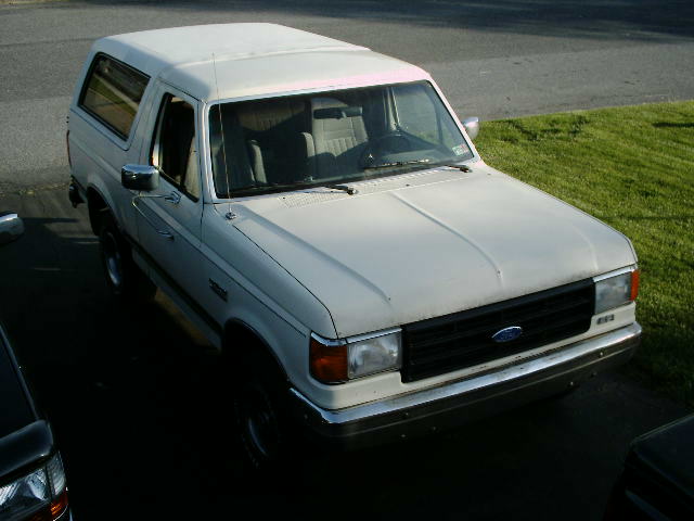White Ford Bronco, 1987 model year, viewed from a high angle, showing front and side