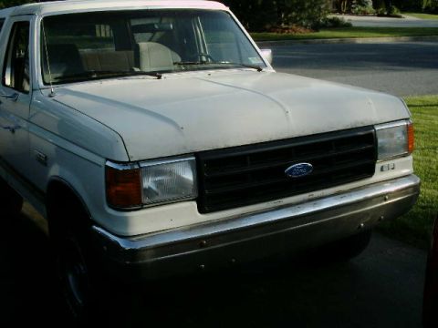1988 Ford Bronco - Front view of a white 1988 Ford Bronco, highlighting its grille and headlights.