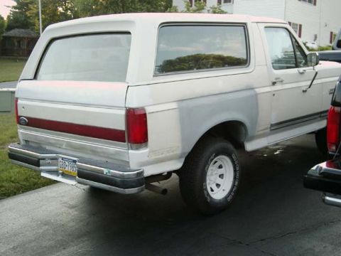 1988 Ford Bronco - This 1988 Ford Bronco shows primer on its rear quarter panel, indicating bodywork in progress.