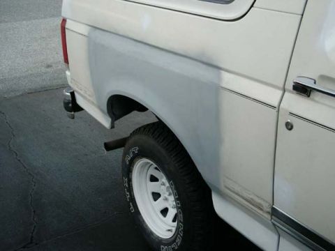 1988 Ford Bronco - This 1988 Ford Bronco shows primer on the rear quarter panel, indicating bodywork in progress.