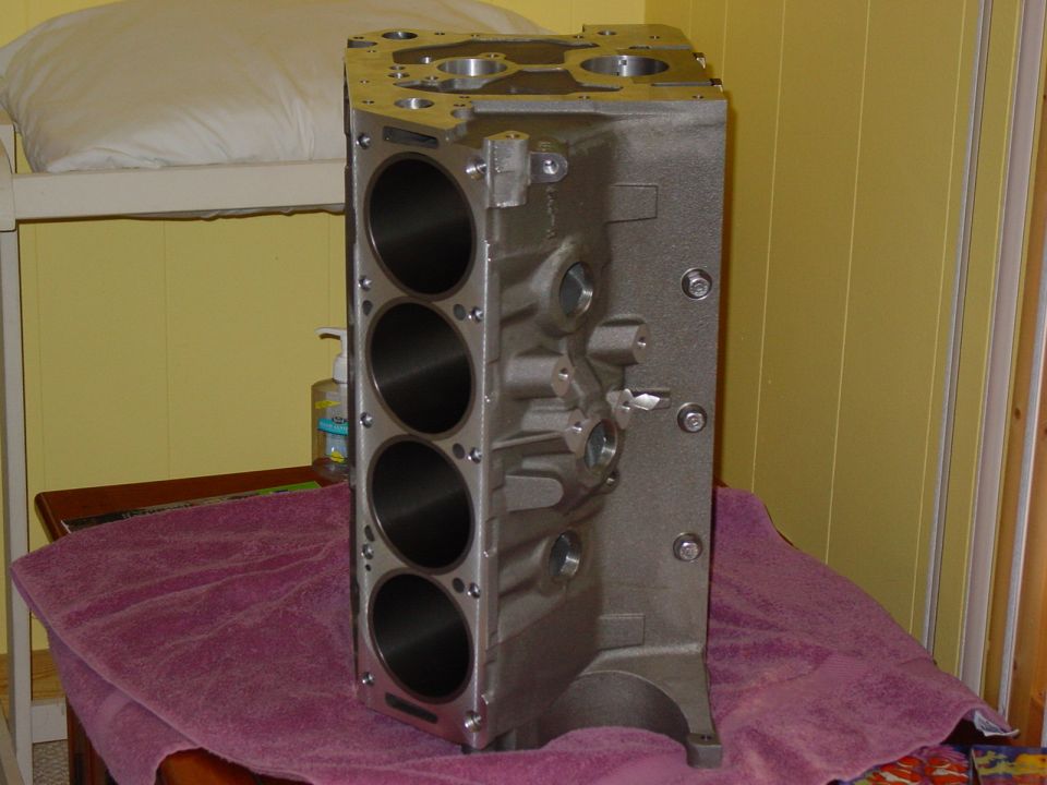 Cast iron V8 engine block with four cylinders visible on the side