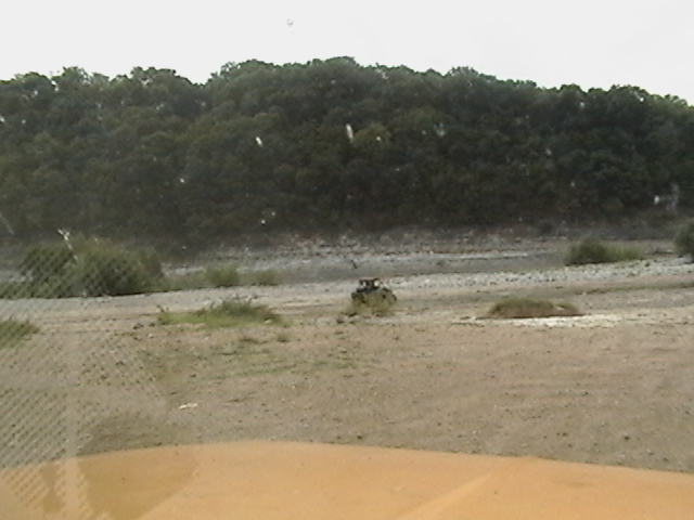 Off-road vehicle in a dusty, outdoor scene