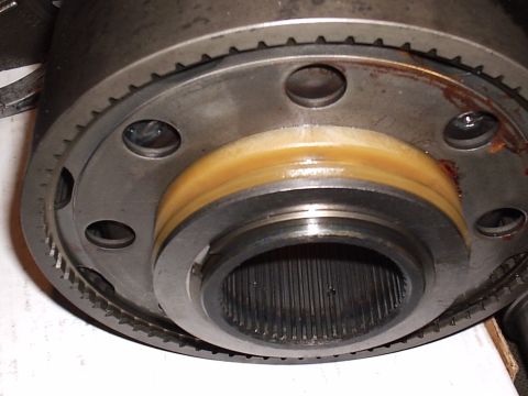 1985 Ford Bronco - Detail of a transfer case sliding clutch assembly showing the toothed outer ring, a tan brass-colored blocker/synchro ring seated in the gr…