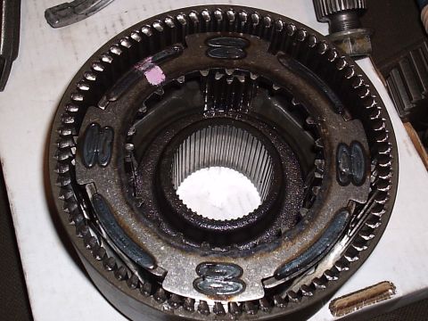 1985 Ford Bronco - Close-up top-down view of a disassembled synchronizer hub and sliding sleeve assembly from a manual transmission, showing the external gear…