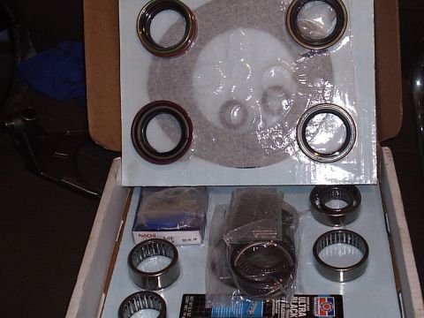 1985 Ford Bronco - An open transmission or transfer case rebuild kit box with new bearings, needle roller bearings, seals, snap rings and O-rings laid out in…