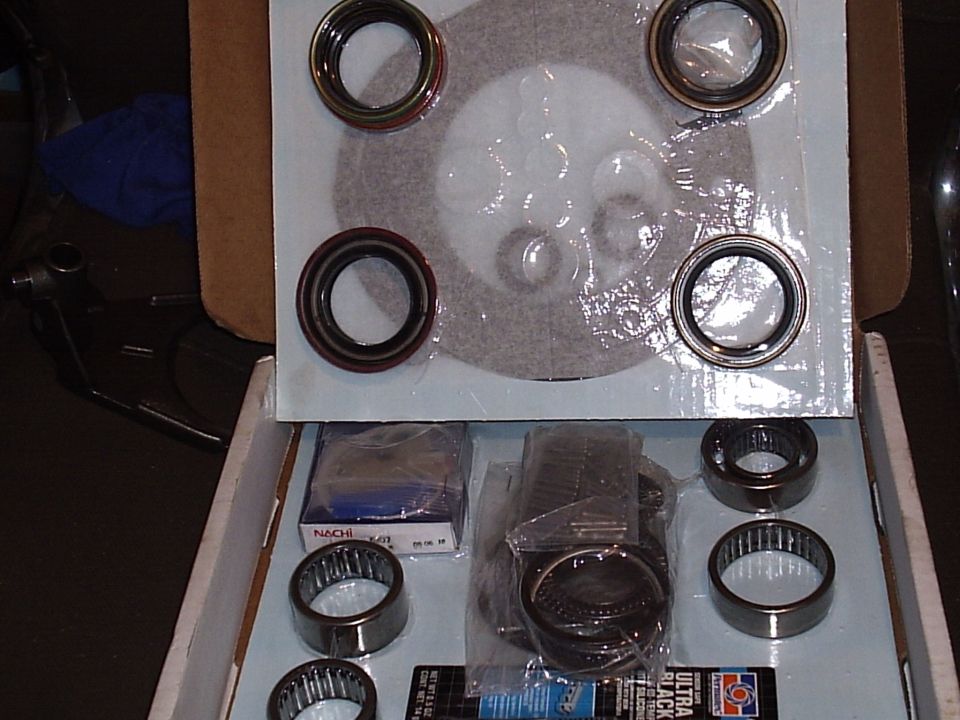 Open gearbox rebuild kit box with new bearings, seals, snap rings and RTV sealant