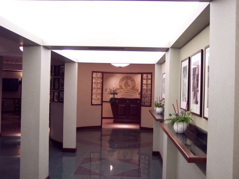 2001 Ford Crown Victoria - Interior hallway leading to the Hall of Fame Club entrance, decorated with framed pictures and floral arrangements.