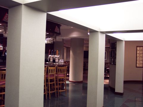 2001 Ford Crown Victoria - A view of a bar area, showing stools, beer taps, and dining tables in the background.