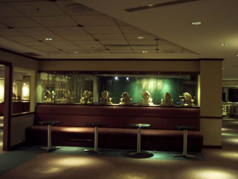 2001 Ford Crown Victoria - A display of busts is visible behind lounge seating and small tables in a dimly lit room.