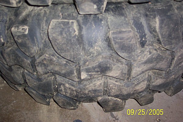 Close-up of a knobby tire tread with a date stamp