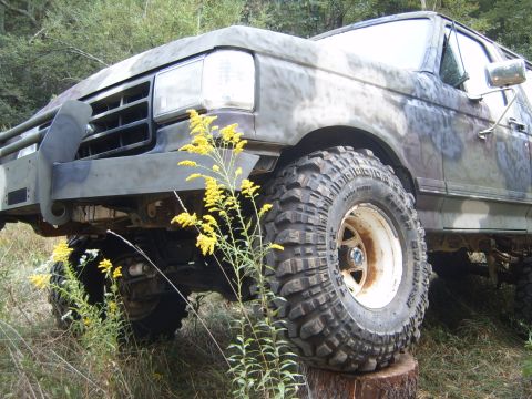 1988 Ford Bronco - This Ford Bronco, likely from the late 1980s, is equipped for off-road adventures with its aggressive tires and protective bumper.