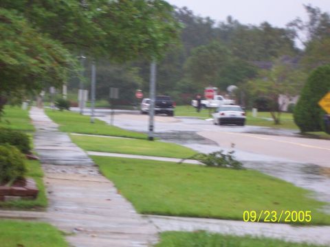 1992 Toyota Hilux - A street scene shows vehicles driving on a wet road after a storm, with a date stamp of 09/23/2005.