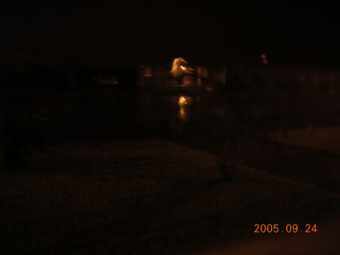 1992 Toyota Hilux - Night scene with reflections on water and distant lights visible.